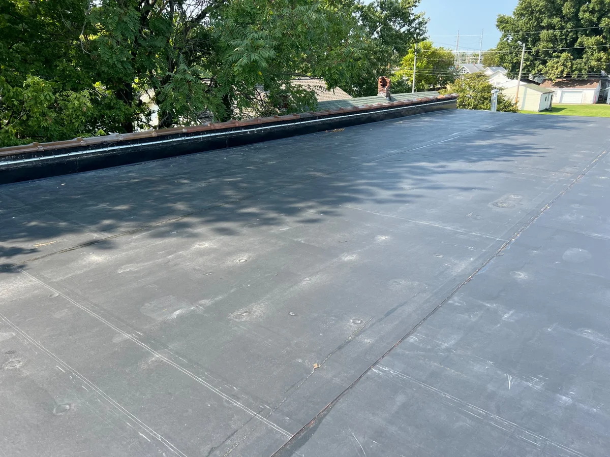 Dark membrane roof surface on a commercial roof replacement project