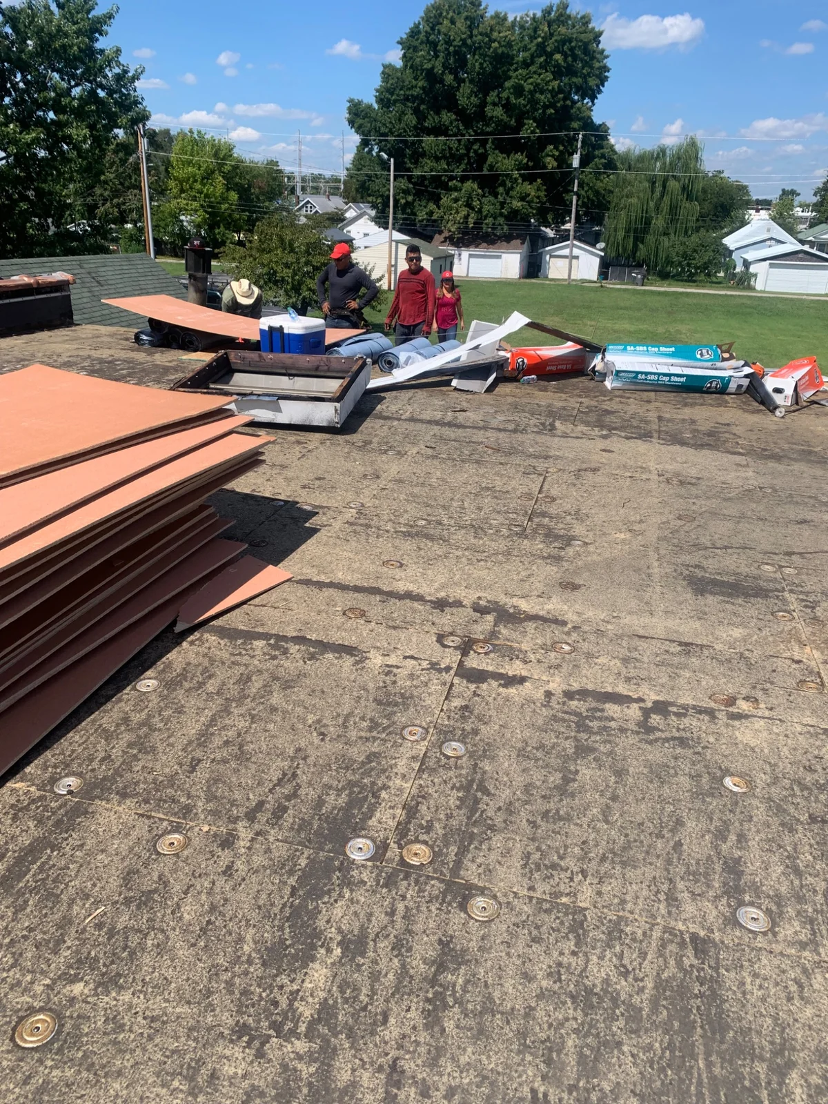 Commercial roof work in progress with exposed surface and roofing materials