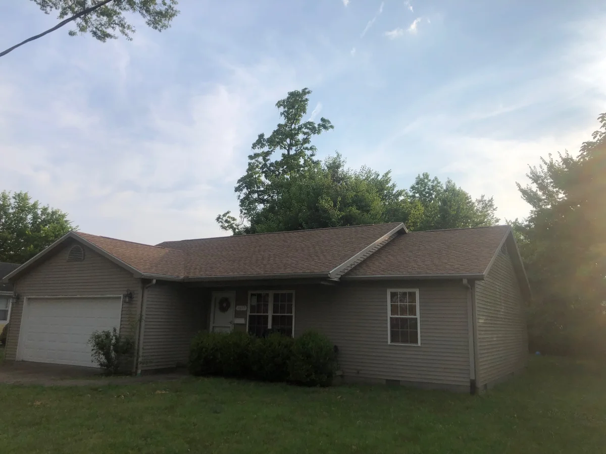 House with a finished shingle roof following roof replacement